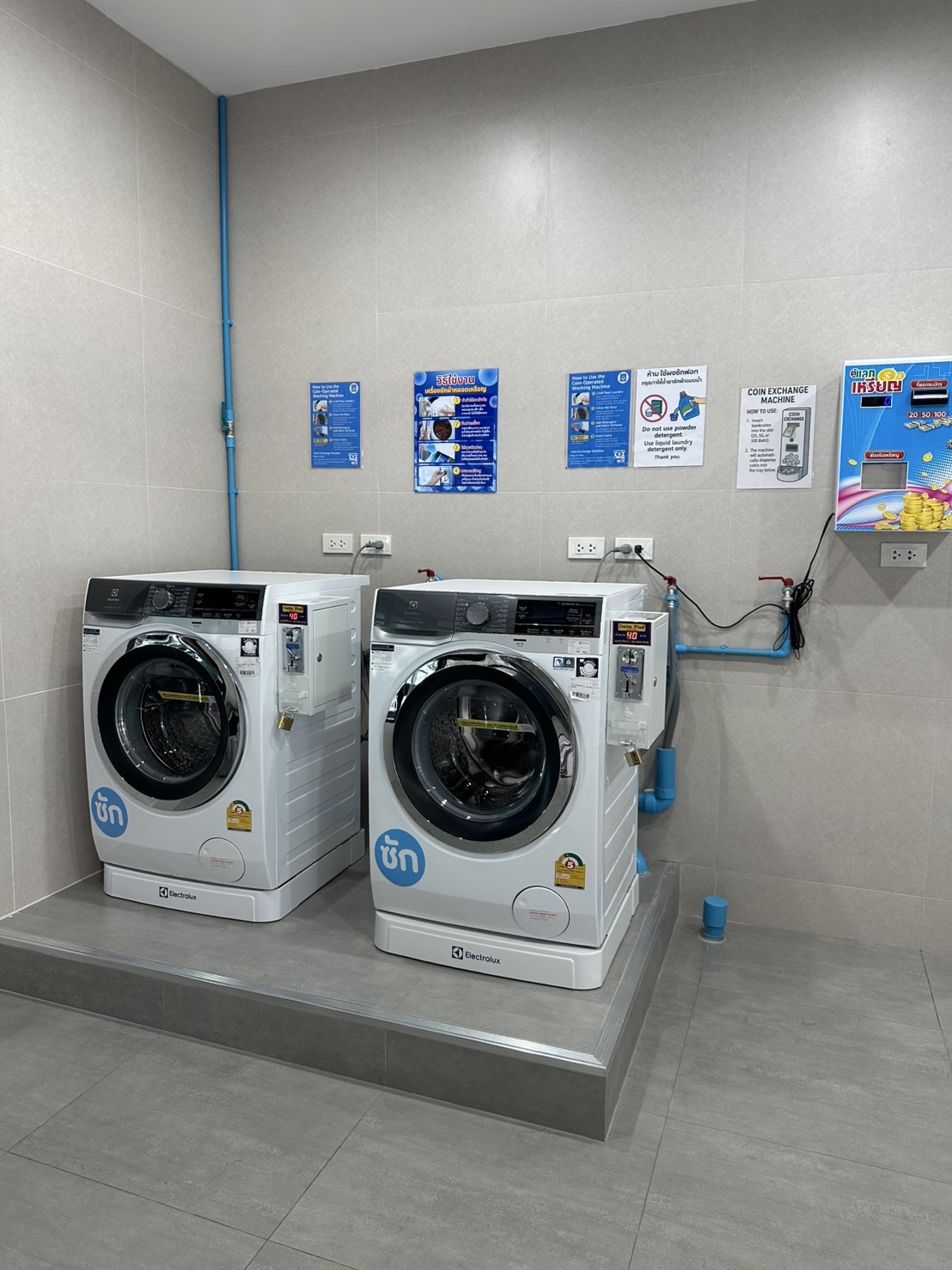 Two washing machines centered within their frame